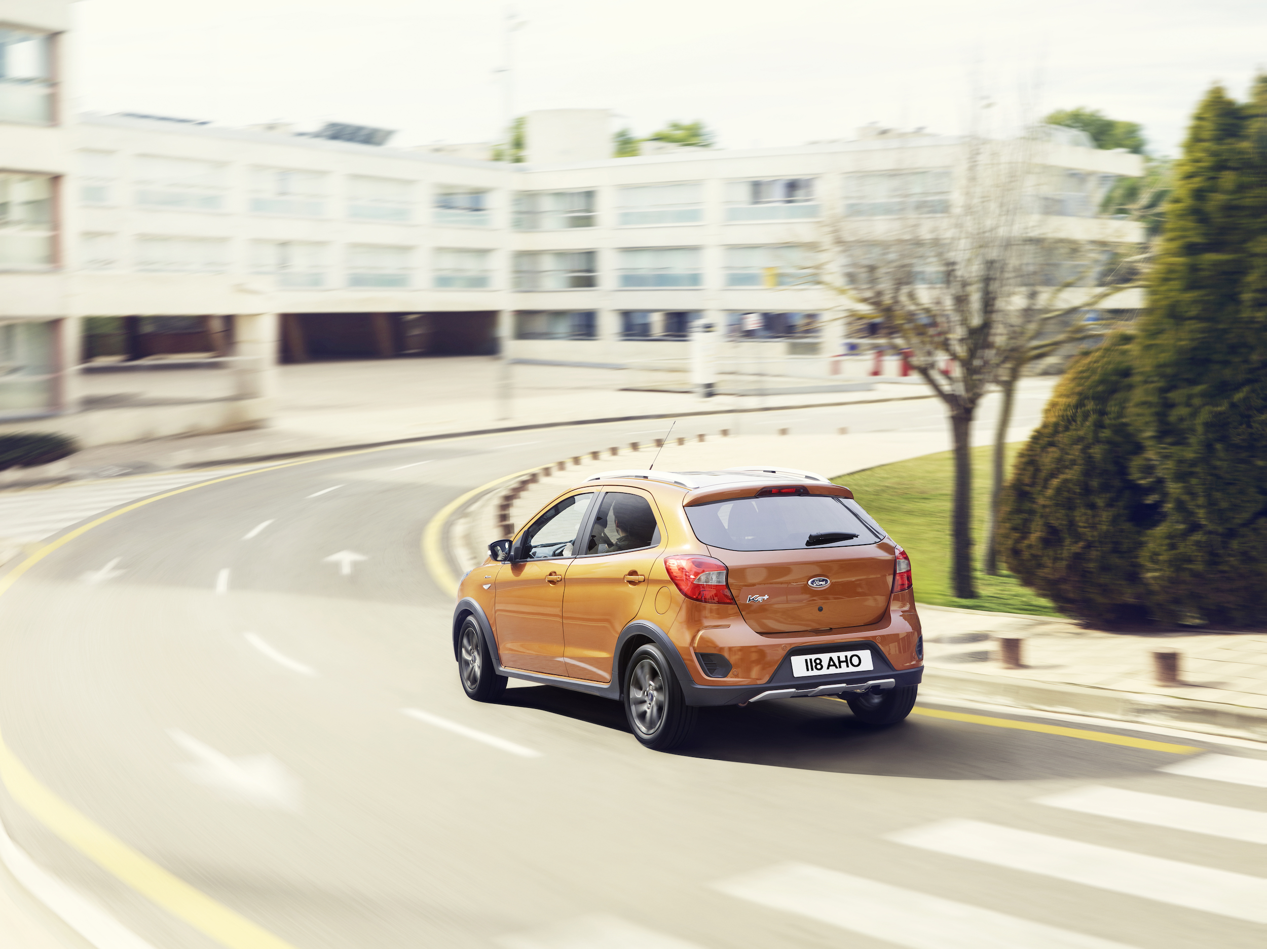 rear view of orange Ford Ka Active driving on a road